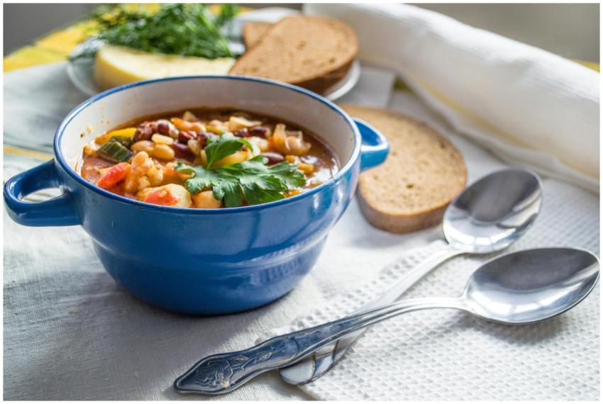 Colorful vegetable soup served in a blue ceramic b