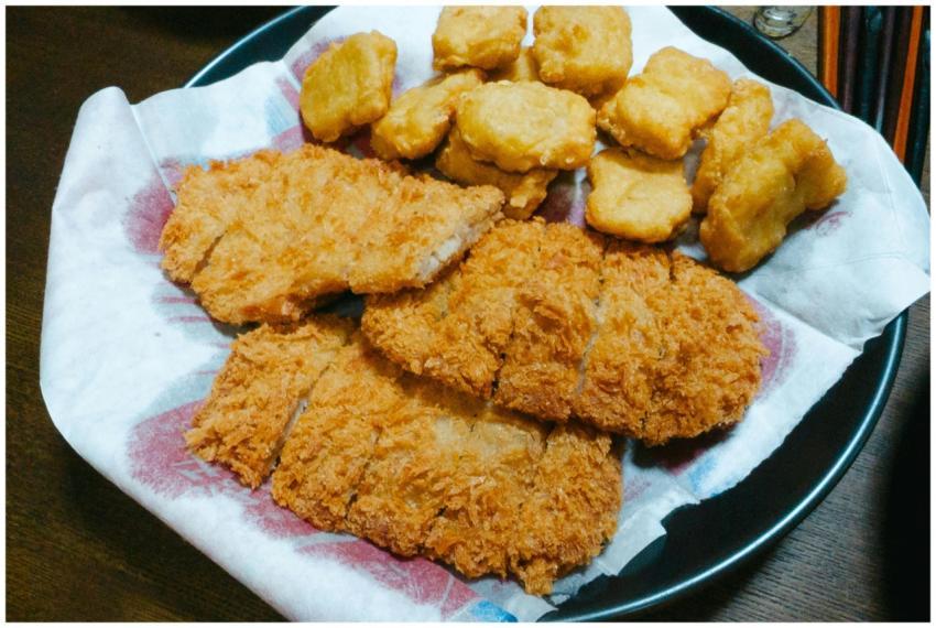 A plate of crispy fried chicken strips and nuggets