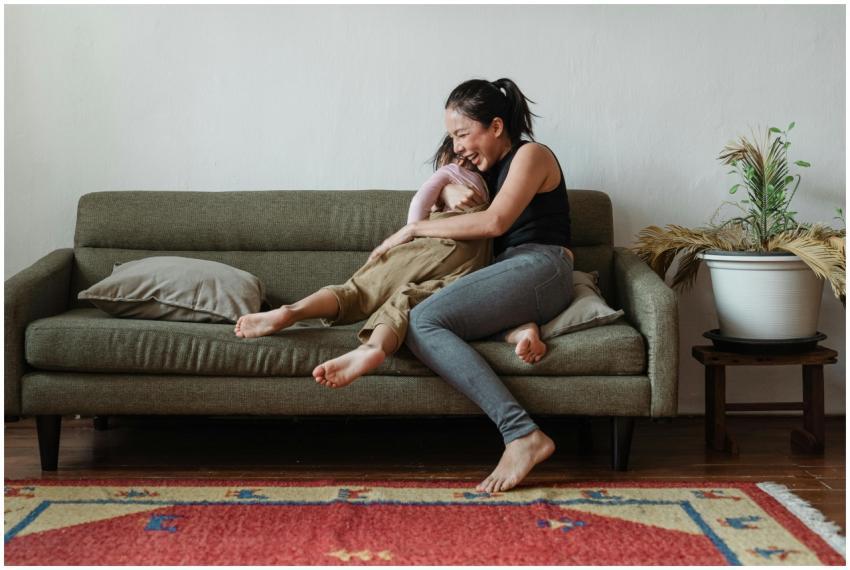 A happy mother and daughter laughing together on a