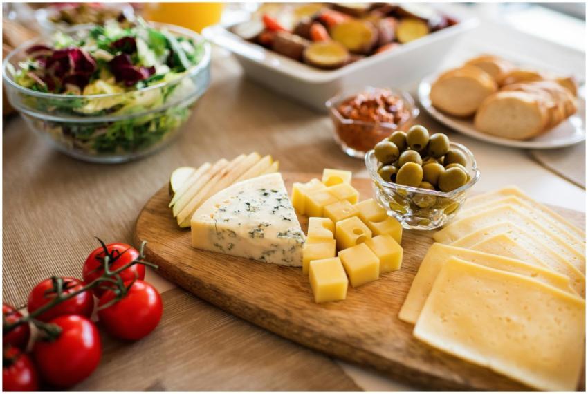A delicious assortment of cheeses, olives, and fre
