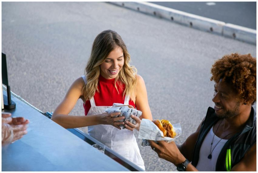 From above of positive multiethnic couple eating t