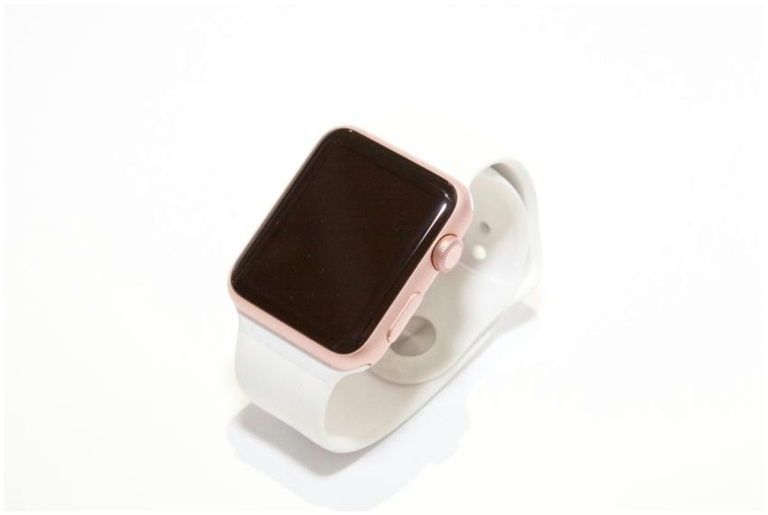 Stylish rose gold smart watch with a white band on