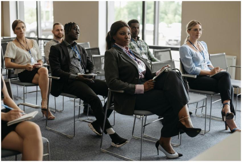 A diverse group of adults attentively listening at