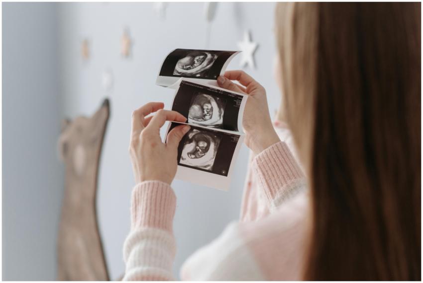 A pregnant woman looks at ultrasound images, showc