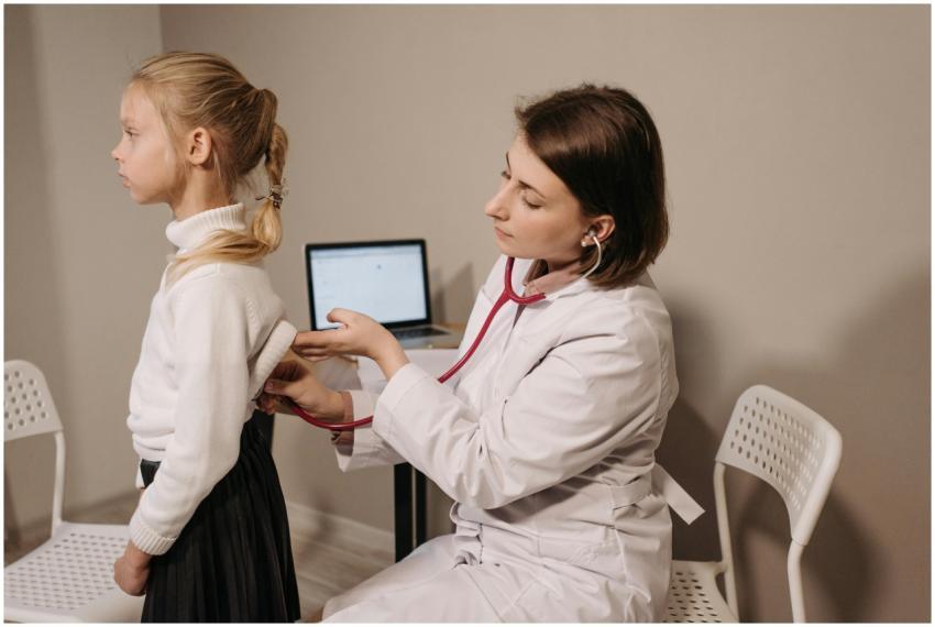 A doctor uses a stethoscope during a child's medic