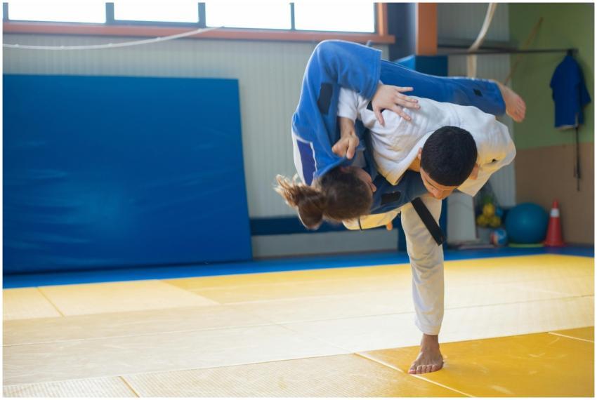 Two judokas practicing a powerful throw during jud