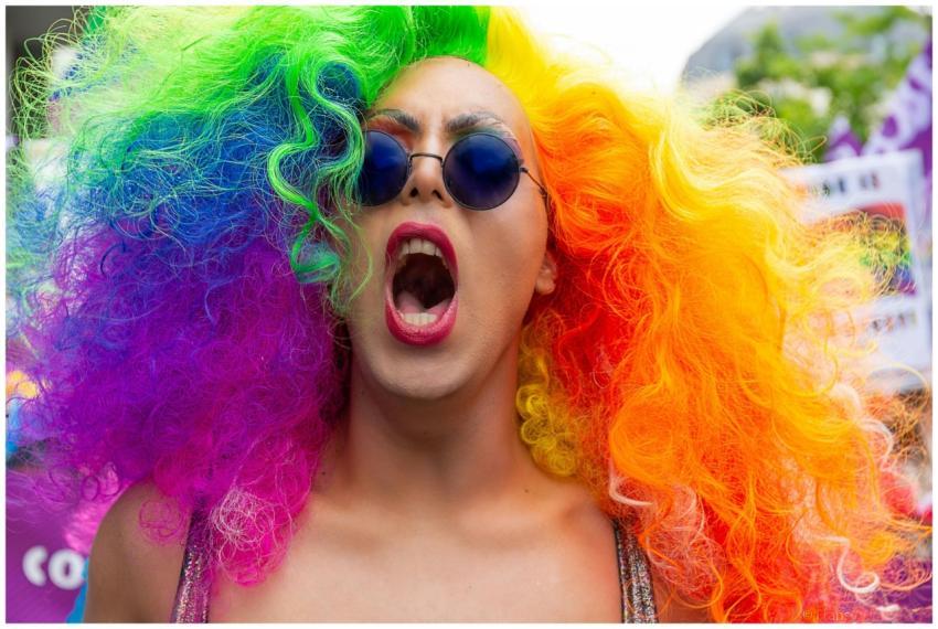 Colorful participant with rainbow wig and sunglass