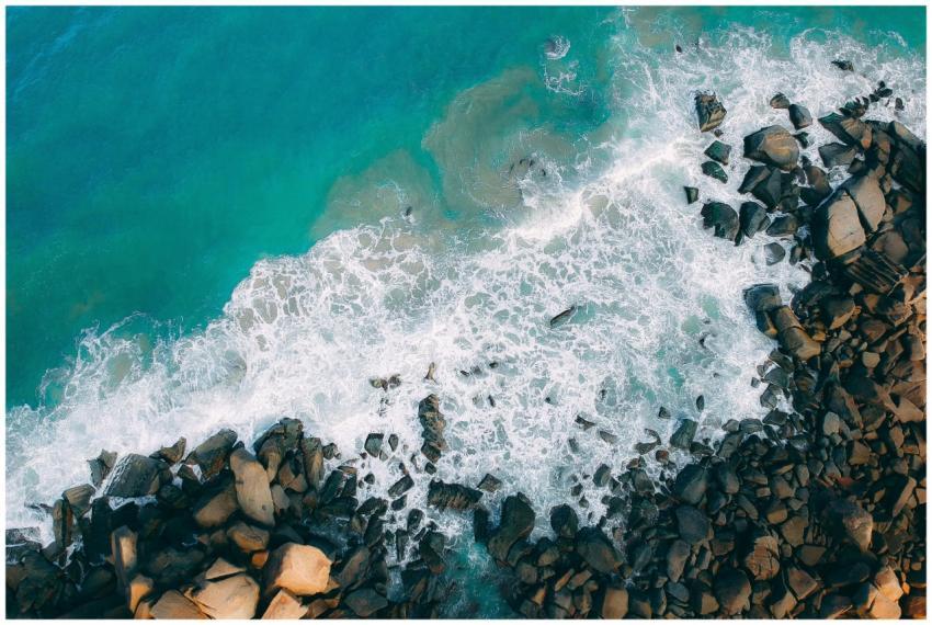 A stunning aerial view of ocean waves crashing on
