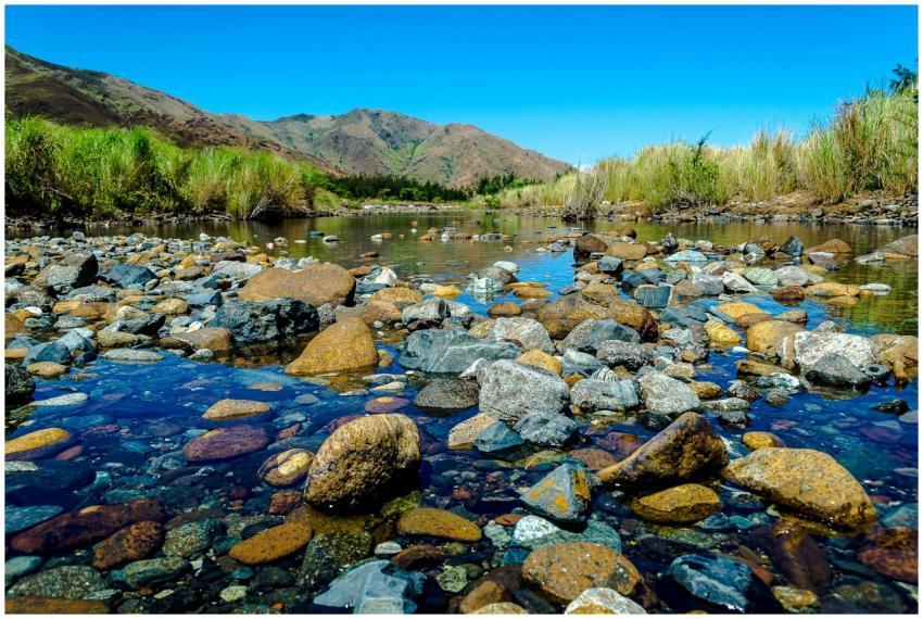 Discover the serene beauty of a river with rocks a