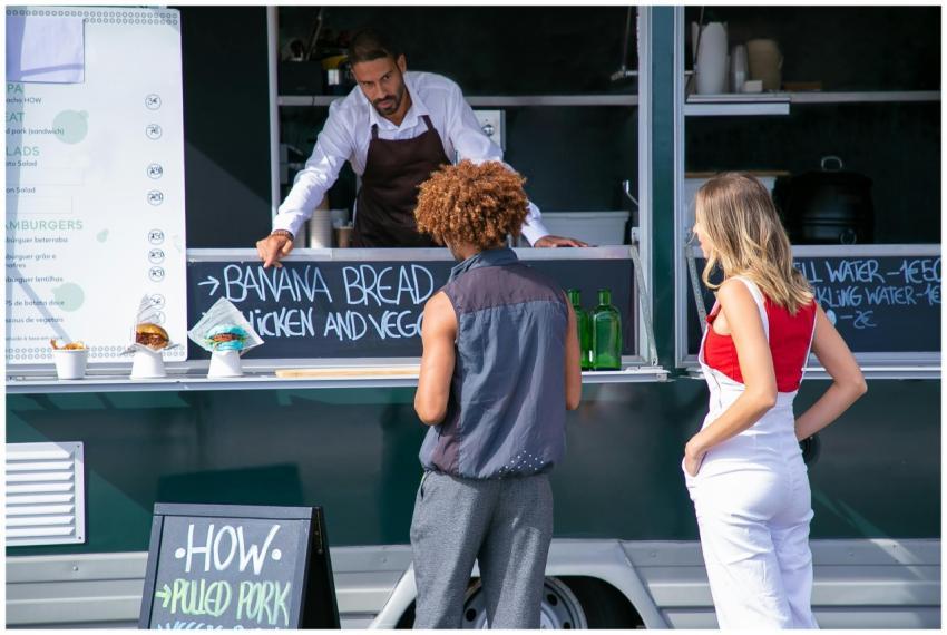 A street food vendor serves diverse customers at a