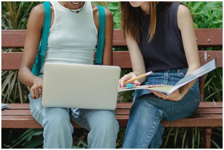 Crop multiethnic smiling female students in casual