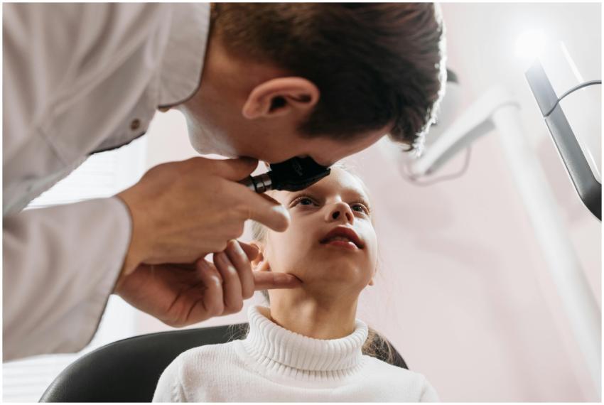 Doctor performs an eye examination on a young girl