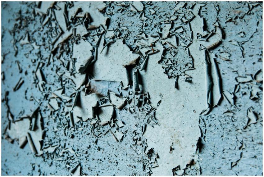 Detailed image of weathered, peeling paint creatin