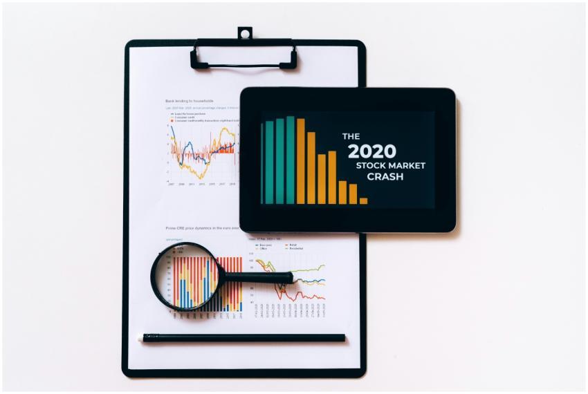 Tablet and clipboard with charts illustrating the
