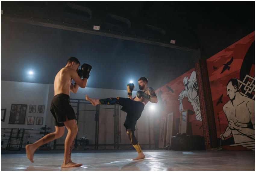 Two athletes engage in a dynamic kickboxing sparri