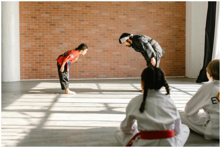 Instructor and children bowing during martial arts