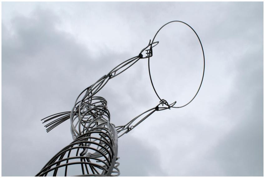 A tall, abstract metal sculpture reaching upwards