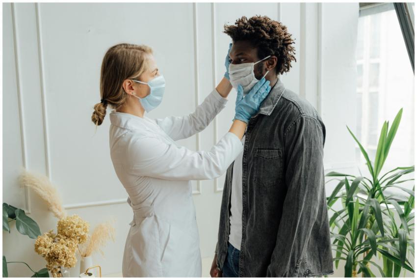 A doctor performs a check-up on a patient, both we