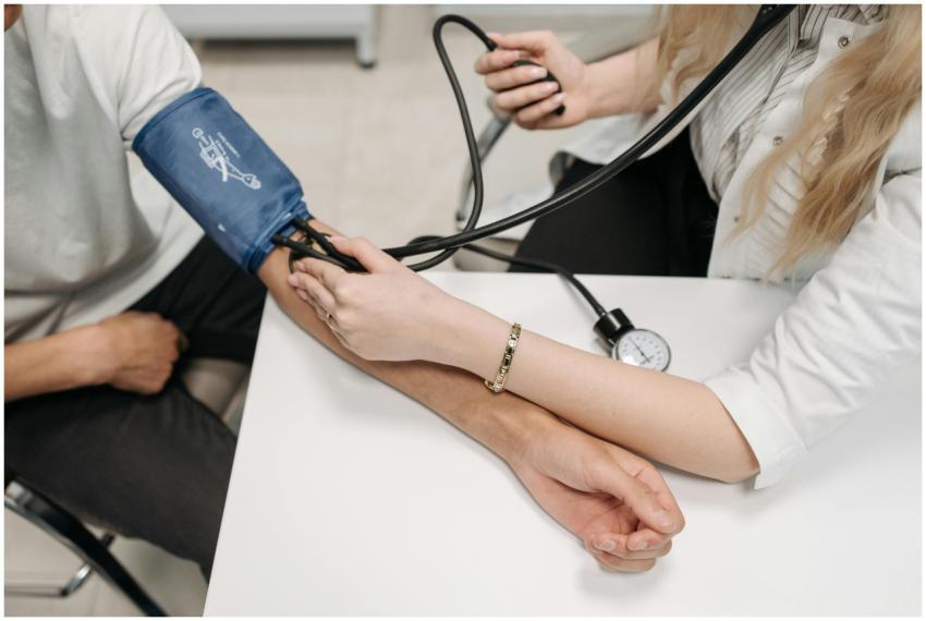 A doctor measures a patient's blood pressure with