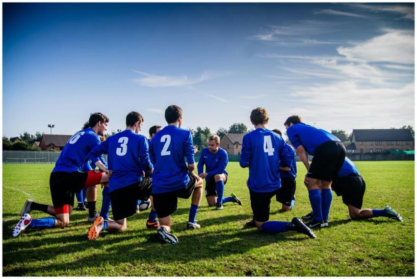 A group of male football players in blue uniforms