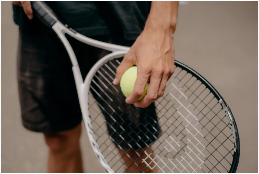 Detailed view of a tennis player holding a tennis