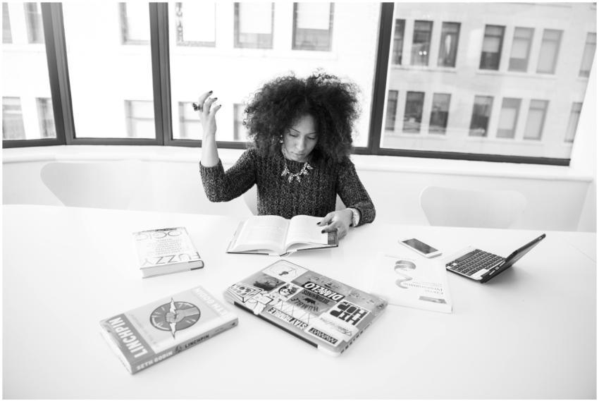 A focused businesswoman reading amongst books and