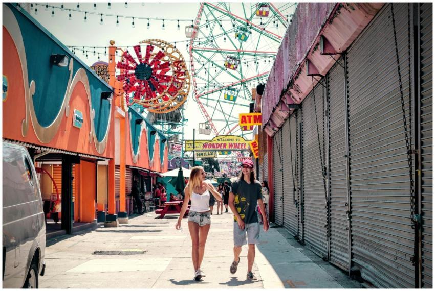 A couple enjoying a sunny day at an amusement park