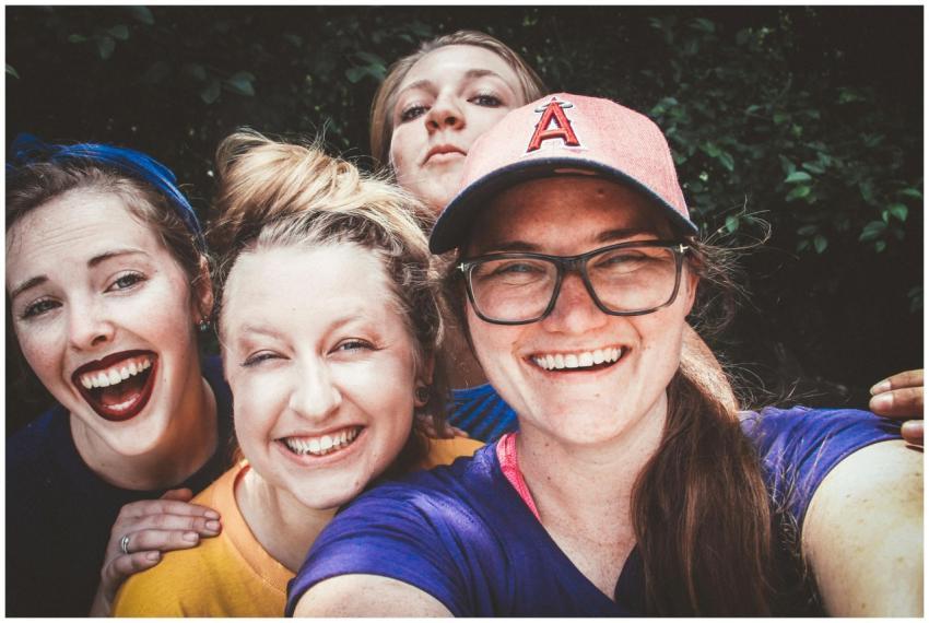 A joyful group of women taking a selfie outdoors,