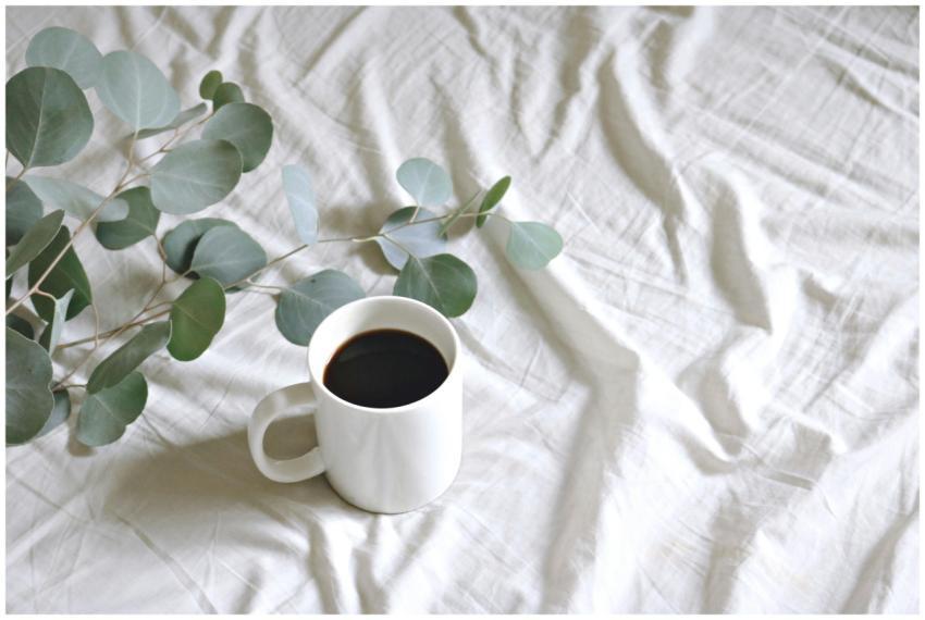 A minimalist setup featuring a white mug of black