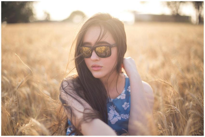 A serene portrait of a woman wearing sunglasses in