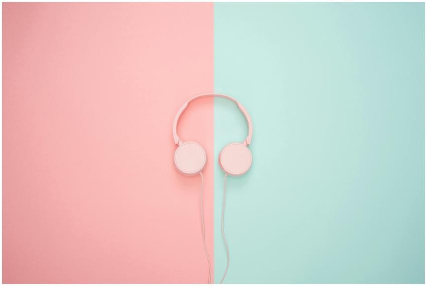 Stylish pink headphones centered over a split past