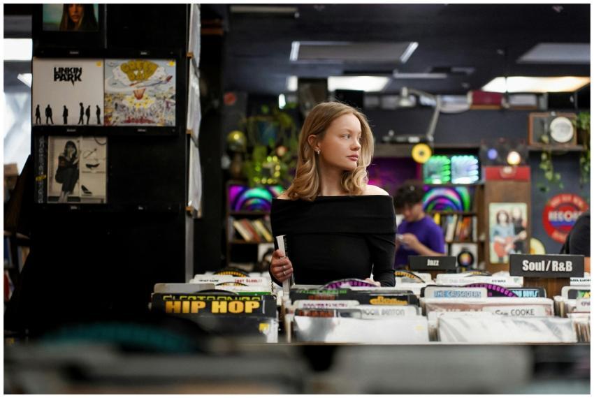 A young woman browsing records in a vibrant Los An