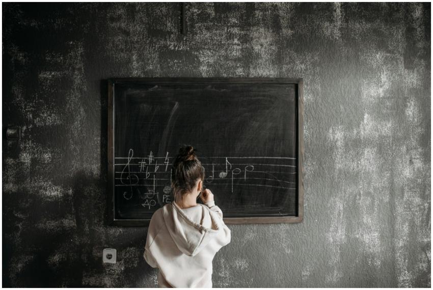 A student in a hoodie learns music notation on a c