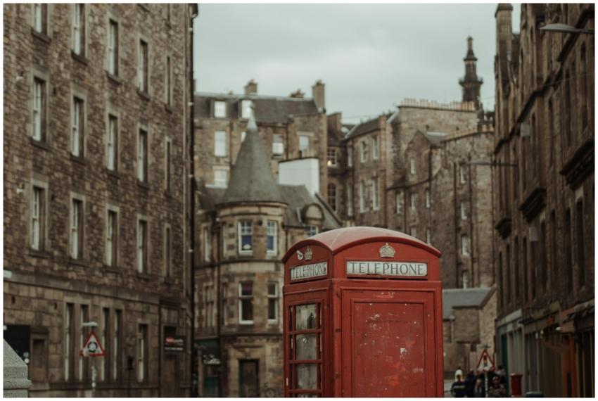 Classic red telephone booth in historic Edinburgh