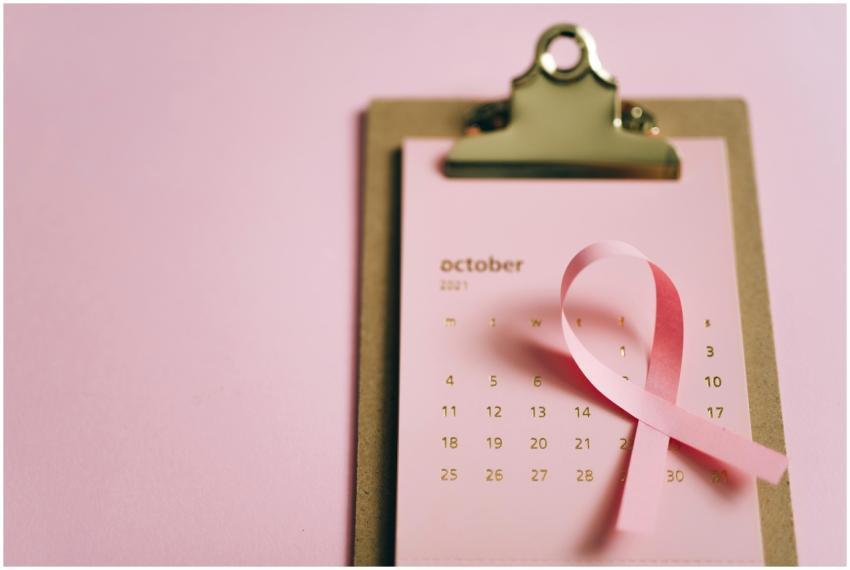Pink ribbon on an October calendar symbolizing bre