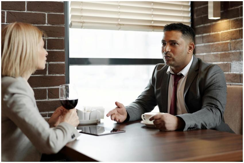 Two business professionals discussing over coffee