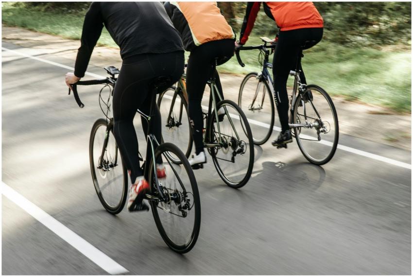 Group of cyclists riding on an outdoor path in bri