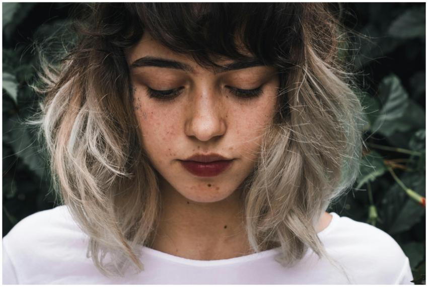 Close-up portrait of a young woman with freckles a