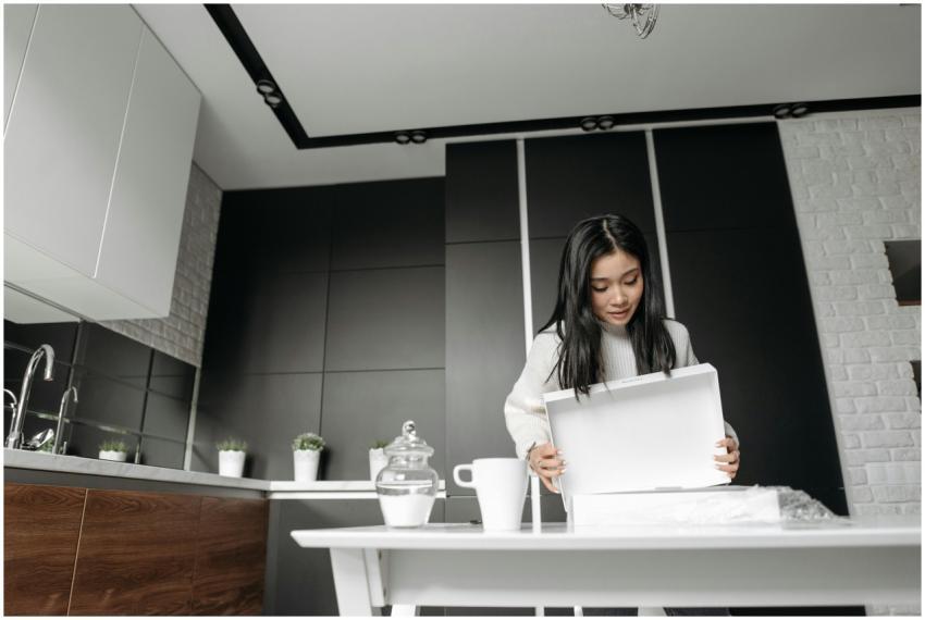 Woman enthusiastically unboxing a package in a mod