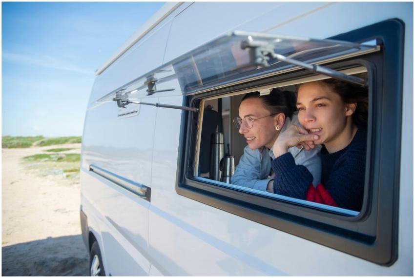 Lesbian couple relaxing in a camper van, embracing
