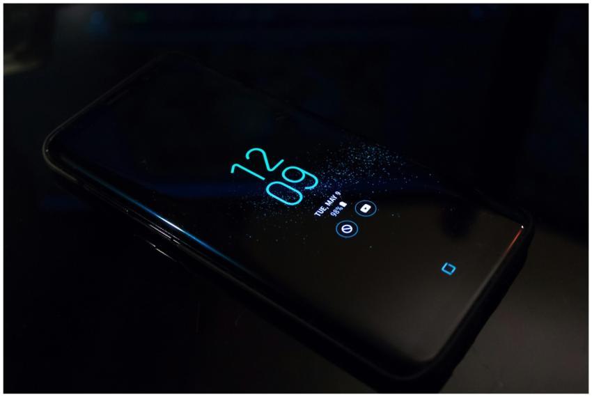 Close-up of a smartphone in the dark displaying di