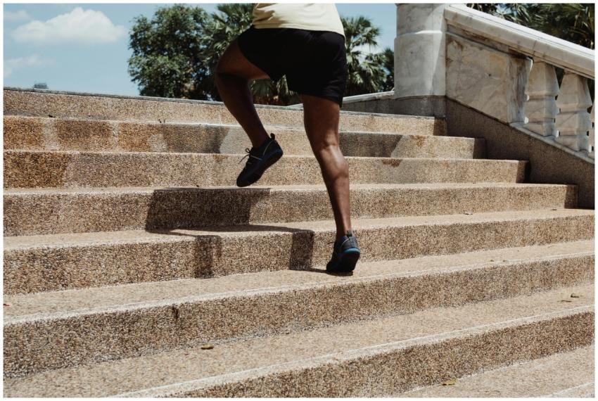 A person running up concrete stairs outdoors, show