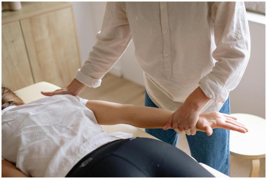 A chiropractor performing an arm adjustment on a p