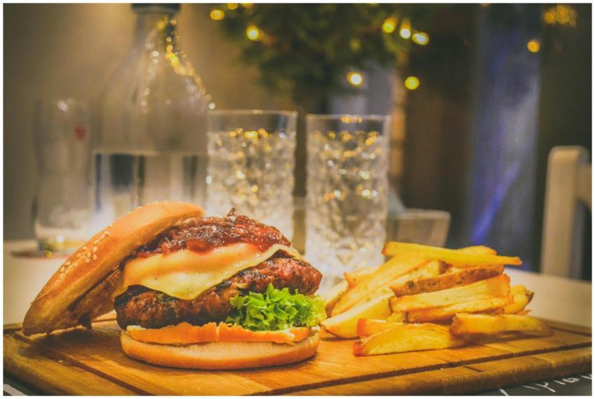 Delicious cheeseburger with lettuce and fries on a