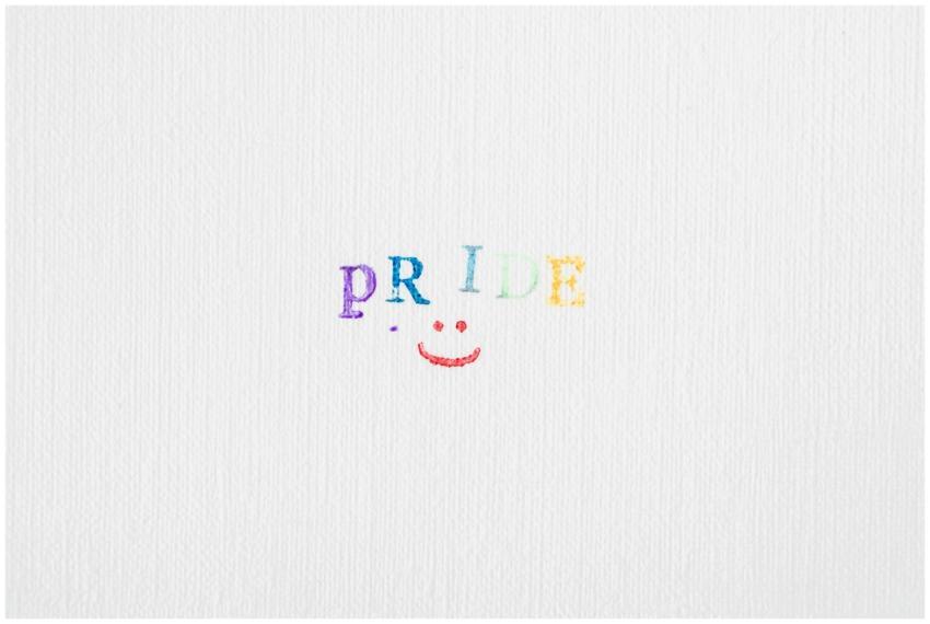 Minimalist pride typography in rainbow colors on t