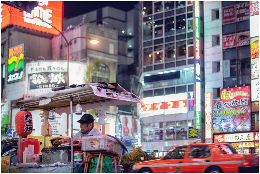 Vibrant Tokyo street scene with a food vendor unde
