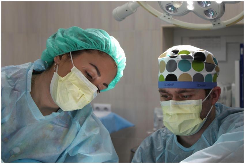 Surgeons wearing masks and scrubs conduct an opera