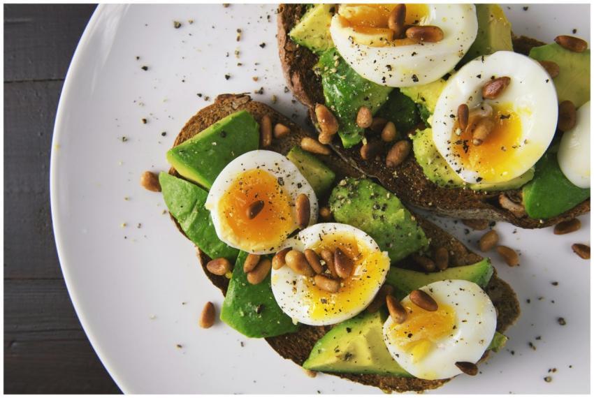 Delicious avocado toast topped with soft-boiled eg