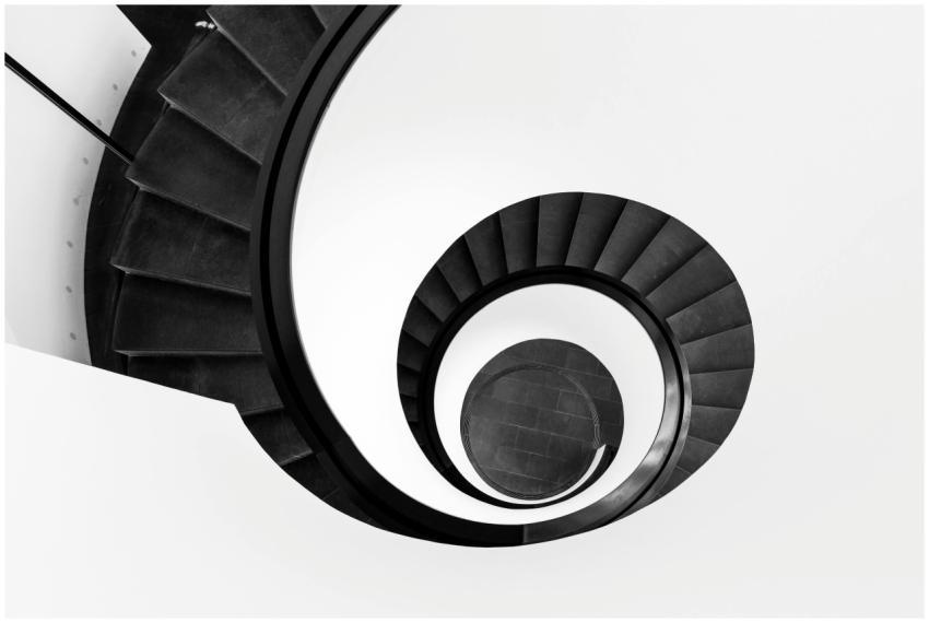 Black and white abstract view of a spiral staircas