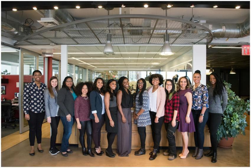 A diverse group of women in technology poses toget
